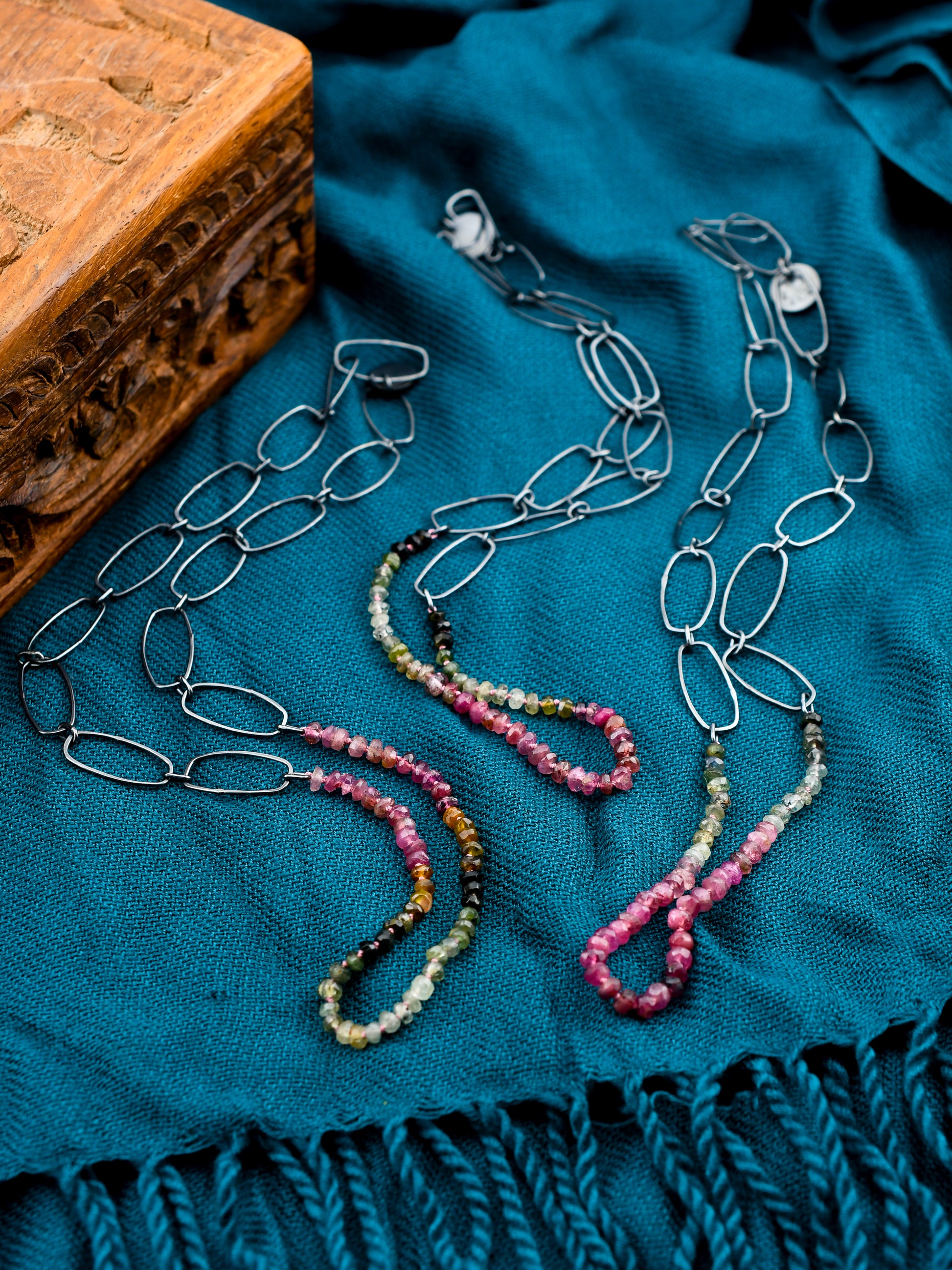 Necklace with colorful beads on a blue fabric background
